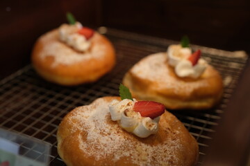 A close-up view of a plain, golden donut, free of glaze or toppings. The classic, fluffy texture and timeless charm of this unadorned treat make it a comforting delight all. High quality 4k footage