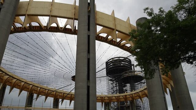view of abandoned world's fair site in flushing corona meadows park in queens new york city (ufo shaped parachute jump and pavilion steel yellow) iconic landmark