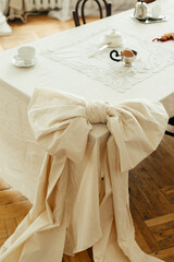 Decor tied tablecloth in the shape of a bow tie on a table in the kitchen living room.