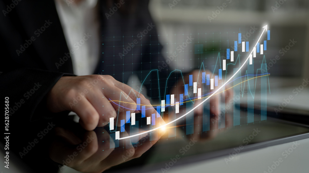 Poster a business professional is analyzing financial data using a digital tablet. a graph overlays the ima