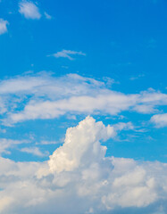 View of fluffy white clouds in a blue sky on a sunny day close-up background of clouds