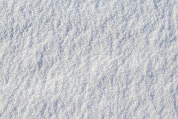 Close-up of a snowy surface with snow crystals a texture and background of white snow a winter frosty da