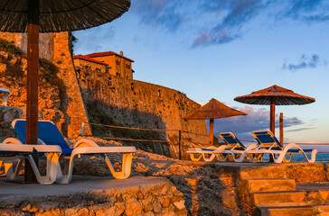 Scenic sunset landscape of beach loungers on a beach terrace in Ulcinj, Montenegro, Europe