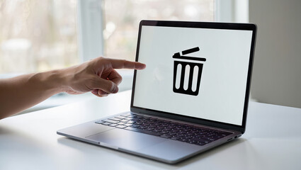 Laptop Screen Displaying Trash Can Icon with Finger Pointing, Representing File Deletion, Data Removal, and Digital Waste Management Concept