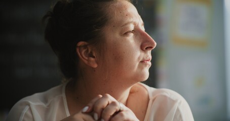 Exhausted Female Tutor Taking Off Glasses, Sitting Alone in Empty Classroom, Having Rest After...