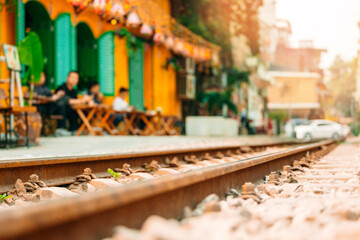 Hanoi street scene: vibrant cafe life and railway tracks in urban Vietnam