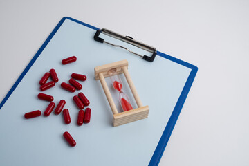 Time to take pills. Alarm clock shows time to take medicine. Taking vitamins or medicine. Concept...