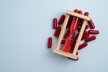 Time to take pills. Alarm clock shows time to take medicine. Taking vitamins or medicine. Concept...
