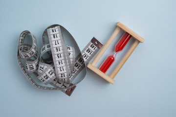 Measuring tape on a light background. Tool for measuring length and volume. Tape for measuring in...