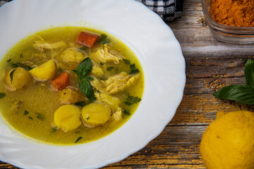 soup with chicken and potatoes seasoned with turmeric, delicious stew...