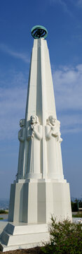 A low-angle, full view of the white stone Astronomers Monument at the Griffith Observatory