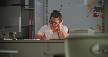 Female Teacher Checking Homework of Students, Grading School Tests After Class, Making Notes....