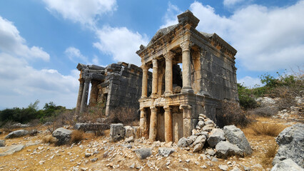 Two monumental tombs, built in the 2nd century AD at the ancient Imbriogion site in Demircili, north of Silifke, Mersin, feature architectural decorations, inscriptions, reliefs, and lion sculptures.