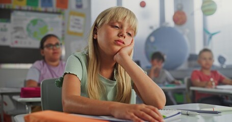 Sad Primary School Girl Sitting at Desk, Getting Tired During Lesson or Upset Because of Bad Grade...