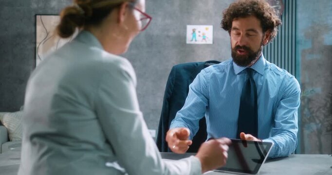 Successful agreement reached as a female client digitally signs a financial contract on a tablet with a smiling bank manager, followed by a warm handshake. Part 23 of the 'Dad’s Day' series.