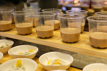 Taiwan brown sugar fresh milk bubble tea glass on white background. Cheese Cream fresh milkfoam with Black pearl tapioca bubble tea with brown sugar syrup glass, tea leaves . High quality photo