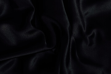 Elegant black fabric draped softly showcasing smooth texture and subtle sheen