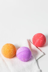 Colorful bath bombs on white towel ready for a relaxing spa experience at home