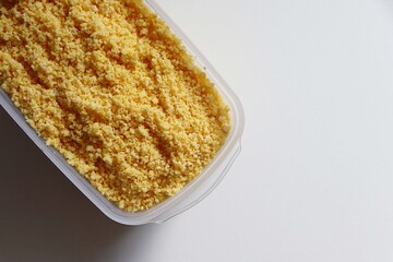 Flaked, pre-cooked flour for brazilian couscous. Moistened couscous mixture. Cuscuz brasileiro.
 
