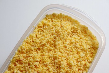 Flaked, pre-cooked flour for brazilian couscous. Moistened couscous mixture. Cuscuz brasileiro.
 