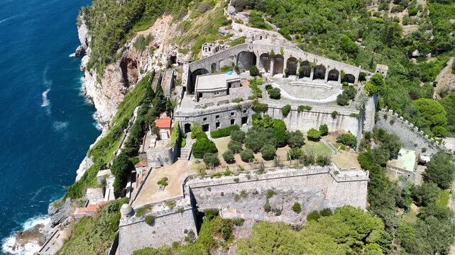 Aerial view of Doria Castle dominating Portovenere coastline from a high rocky promontory
