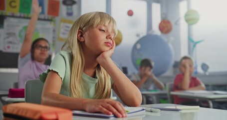 Depressed Elementary School Girl Sitting at Desk, Getting Upset About Bad Grade on School Test or Bored During Lesson. Team of Smart Diverse Kids Studying Environmental Science in Modern Classroom. - Powered by Adobe