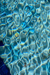 Sunlit Pool Water Surface Close-Up as Abstract Background