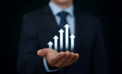 Businessman in dark suit holds glowing arrows rising upward symbolizing growth success finance and career progress