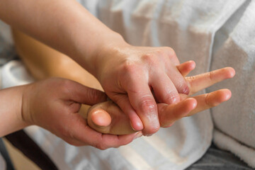 Decontracting hand massage to relieve tension and pain. Spa, health and relaxation concept