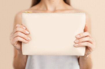 Blank leather cosmetic bag in hand mockup, ai generated
