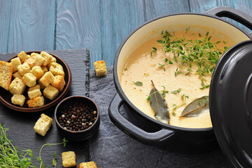 creamy salmon soup with herb in a pot