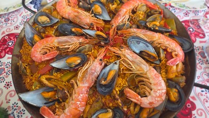 Delicious traditional spanish paella with seafood in large pan. Typical cuisine of Spain. Valencian cuisine