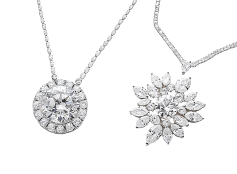 Two white gold diamond necklaces, one with an oval-cut center stone and the other featuring multiple marquise-cut diamonds in different sizes.