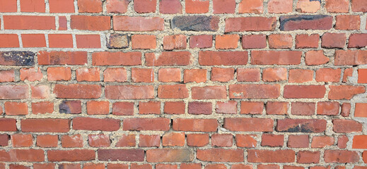 Old red brick wall texture – weathered and brittle surface in high resolution for backgrounds and design