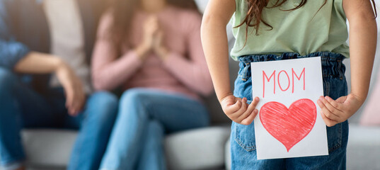 Mother's Day Gift. Cute Little Girl Prepare Greeting Card With Big Drawn Red Heart To Her Loving Mom, Kid Holding Her Present Behind Back, Congratulating Her Mommy With Holiday, Selective Focus