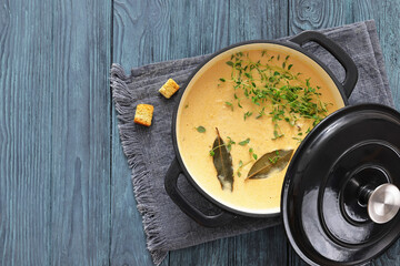 creamy salmon soup with herb in a pot
