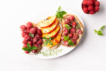 Assortment of homemade juicy sandwiches with cream cheese, peach, raspberry, chocolate paste,...