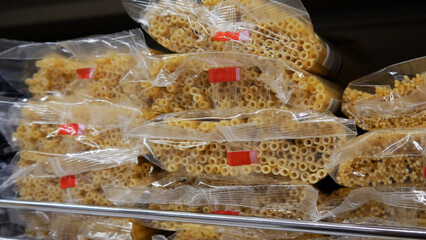 Close-up of many pasta packagings on a retail display