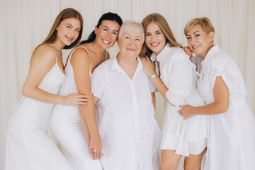 Family of women wearing white dresses posing together