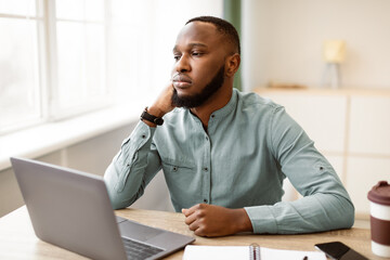 Unhappy Employee. Bored Black Business Guy Sitting At Laptop Tired After Boring Office Work At...
