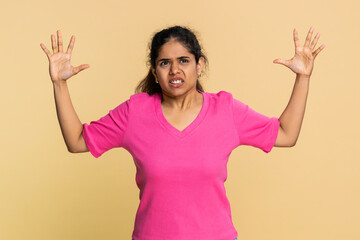 Indian woman dramatically waves hands, mouth wide open, vividly showing strong excitement or panic....