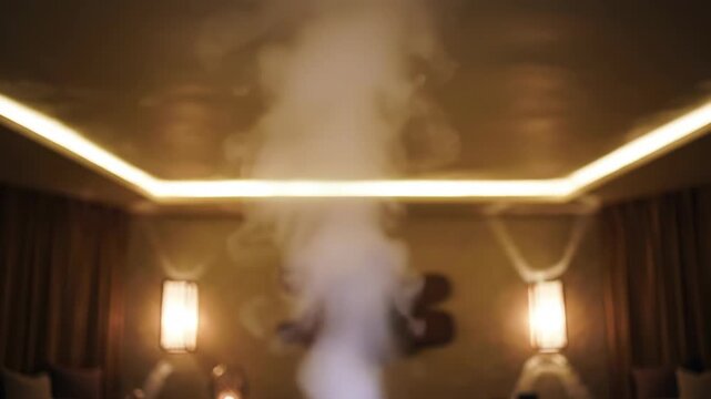 Relaxing aromatherapy diffuser emitting mist in a dimly lit spa setting for meditation and wellness videos, creating a calming atmosphere