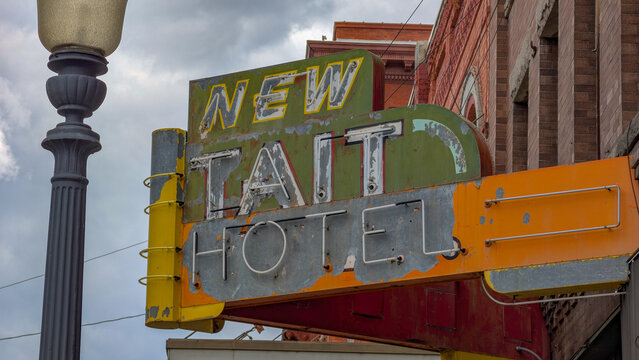 A Faded and Weathered "New Tait Hotel" Neon Sign in Downtown Butte, Montana on June 27, 2025 in Butte, Montana 