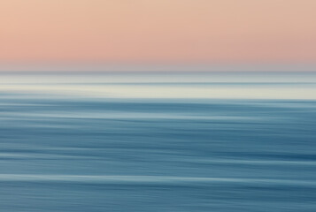 Abstract ocean at sunset  with fog over the water.
Intentional camera movement image.