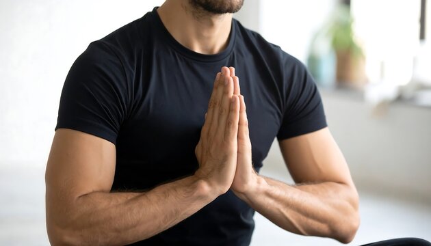 Man in yoga pose, hands clasped