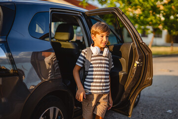 Elementary school student exiting car in the afternoon