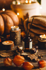 Hello autumn, cozy atmosphere, slow living. Fall mood. Reed diffusor, pumpkin, aromatic candle,...