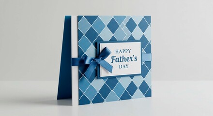 A father's day card with a blue argyle pattern and a blue ribbon on a white surface with a simple background