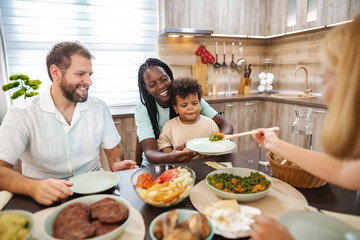 Family enjoys a vibrant meal together in a cozy kitchen