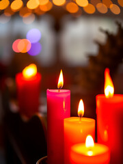 A colorful display featuring four candles, each casting a warm glow in a different vibrant hue, enhancing the ambiance with their lively colors 8K , high-resolution, ultra HD,up32K HD